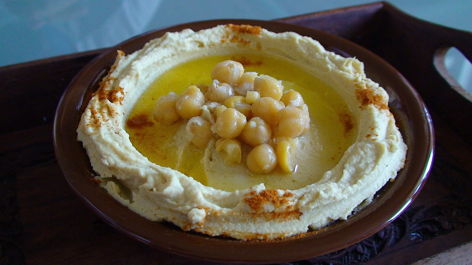 Hummus topped with whole chickpeas, olive oil and paprika